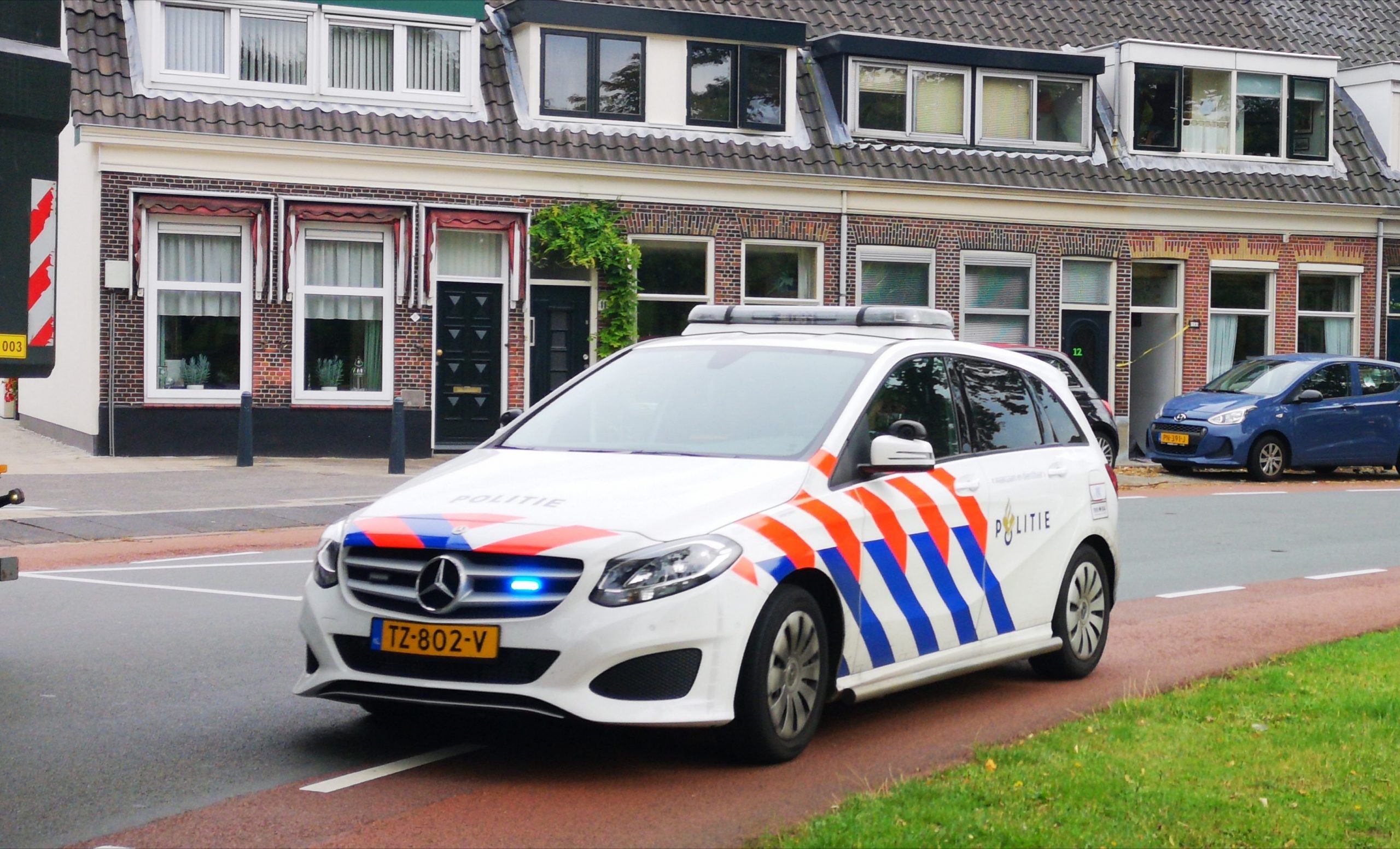 Mercedes B-klasse van de Nederlandse politie met zwaailichten en sirenes aan (politieauto met blauwe lampen)